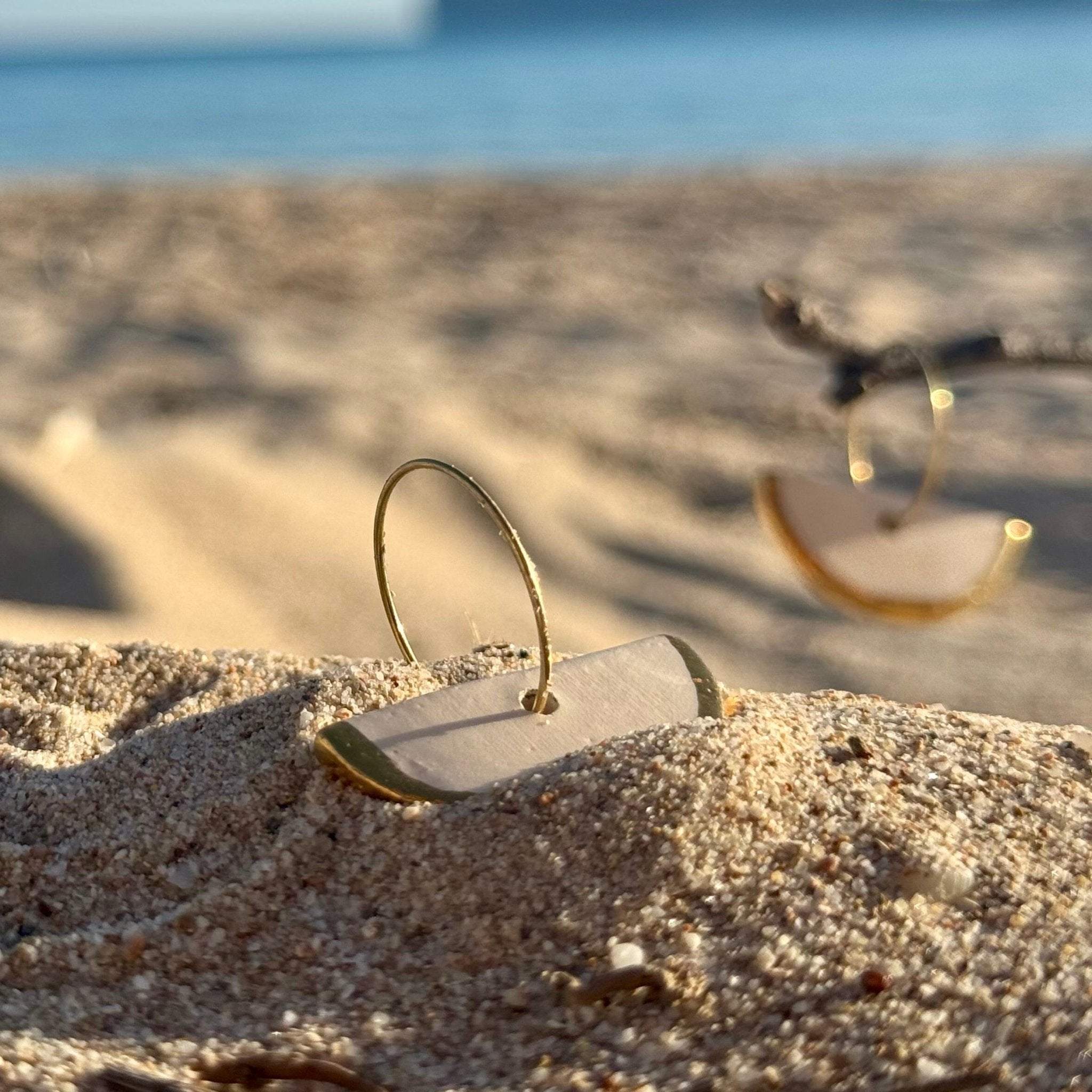Doraluna | Handcrafted white ceramic dangle earrings with gold luster - Glow